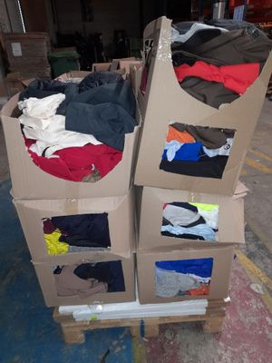 a carton full of clothes sitting on a pallet