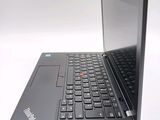 a black laptop with a red button on the keyboard