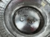a close up view of a metal object with a hole in it