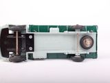 a green and white toy train car on a white surface