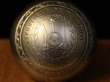 a silver coin sitting on top of a wooden table