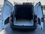 the back of a white van with its doors open in a parking lot