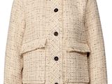 a white jacket with buttons on the shoulders and a collar