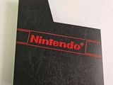 a close up of a nintendo logo on a black card