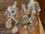 a glass chandelier hanging from the ceiling in a store
