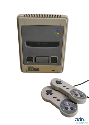 two game controllers sitting next to each other on a white surface