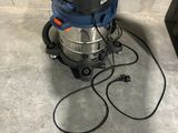 an image of a wet dryer sitting on the floor in a garage