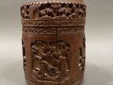 an old wooden box with carvings on it sitting on top of a table