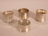 three silver cups are sitting on a table with a white background