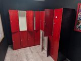 several red lockers in a room with a skylight above them