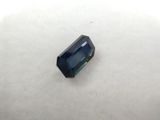 a blue sapphire stone sitting on top of a white surface