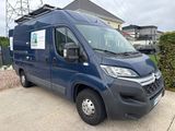 a picture of a blue van parked in front of a house