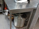 a stainless steel counter with a mixer on it