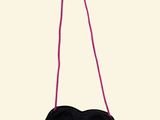 black heart shaped purse hanging from a pink string