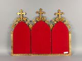 three red chairs with gold trims and crosses on top of them