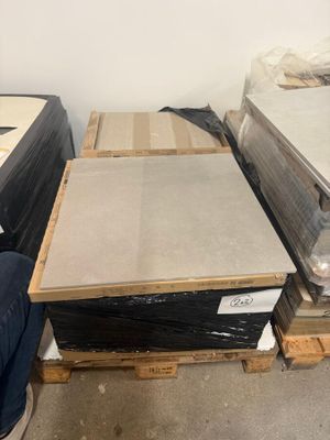 a man sitting on the floor in front of a pile of mattresses