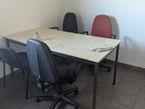 two chairs and a table in the corner of a room