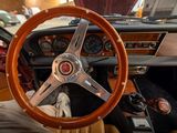 a steering wheel and dashboard of a car in a showroom