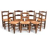 six wooden chairs arranged in a circle on a white background