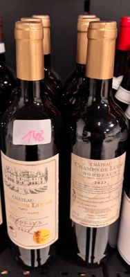 several bottles of wine are lined up on a shelf