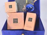 a blue box with three boxes of perfume and a blue ornament in it