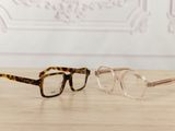 two pairs of glasses sitting on top of a wooden table