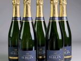 four bottles of champagne are lined up in a row