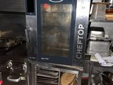 a large commercial oven in the middle of a kitchen