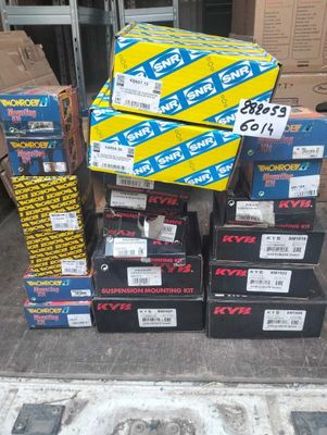 several boxes of assorted skateboards stacked on top of each other