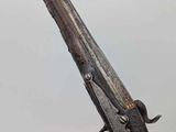 an old gun with a wooden handle on a white background