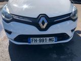 a close up of a white car parked in a parking lot
