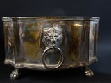 an image of a silver box with a lion ' s head on it