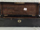 a black suitcase sitting on a table with a tag on it