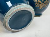 two blue vases sitting next to each other on a table