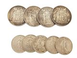 six different types of silver coins on a white background