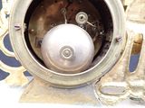 a silver clock with a white ball in the middle