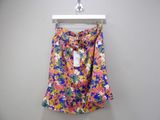 a close up of a skirt hanging on a hanger on a wall