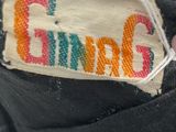 a close up of a person ' s hand holding a shoe label