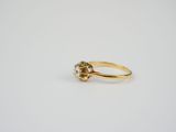 a yellow gold ring with a white diamond on top