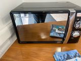 a microwave that is sitting on a table with a dvd