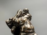 statue of a man wrestling with another man on his back