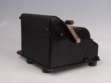 a black toaster with a wooden handle on a white surface