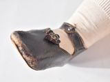 a close up of a person ' s foot with a pair of shoes on it