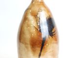 a brown vase with a black and white design on it