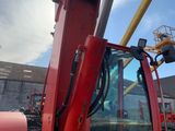 a red crane that is parked in a parking lot