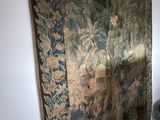 a tapestry hanging on the wall next to a toilet