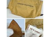 the louis vuitton pouch is open and has a tag on it