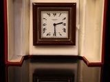 a small clock sitting in a box on a table