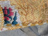 a close up of a woven basket with a flower on it