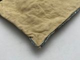 someone is sewing a piece of cloth on a white surface